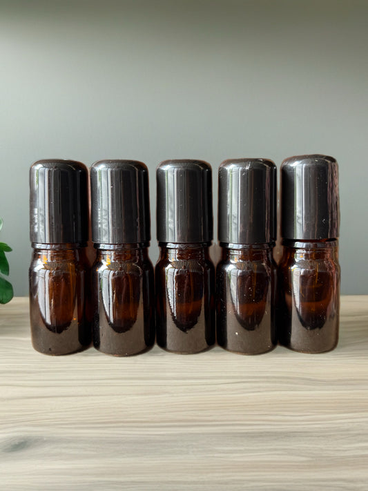 2 mL amber glass bottle with precision drip top and black lid.